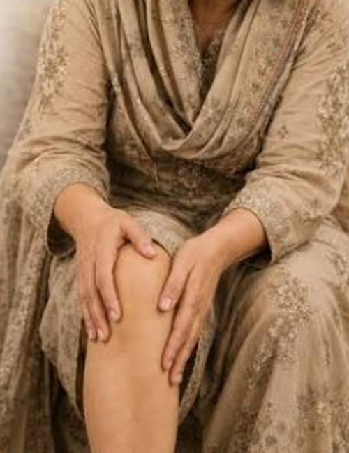 Hands resting on a sore knee, the everyday joint pain OSTRUCE is made for